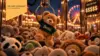 BGO Chief Economist thumbnail featuring a teddy bear wearing a green Beta sweater being lifted by a claw machine, surrounded by plush animals at a brightly lit carnival. A price-per-play sign with dollar symbols illustrates the article’s theme of the shape and price of beta in commercial real estate.