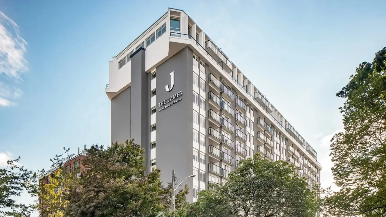 Exterior of The James at Harbour Towers, a modern multifamily residential building in Victoria, British Columbia, featuring balconies and a grey-and-white facade.